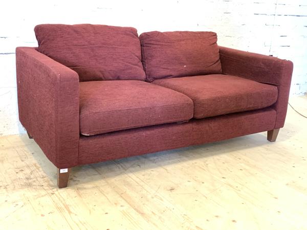 A modern two seat sofa, upholstered in purple fabric, raised on square tapered supports, H65cm,