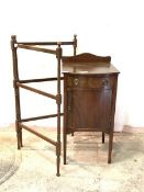 An Edwardian mahogany bow front bedside table, with raised back over drawer and cupboard, raised