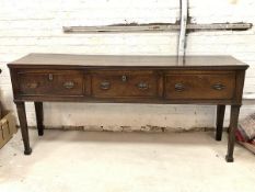 An 18th century and later oak dresser base, the three plank rectangular moulded top over three