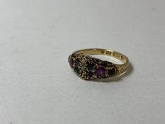 An 1899 Birmingham 15ct gold gem set ring with seed pearls, emeralds and spinel's, size Q, weighs