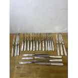 A set of twelve 1921 fruit knives and forks with mother of pearl handles and Sheffield silver blades