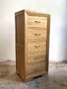 A contemporary light oak tall chest, fitted with five drawers, H120cm, W53cm, D43cm