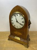 An Edwardian mahogany lancet shaped mantel clock with lion mask handles to sides, brass plaque