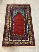 A Hand-knotted prayer rug, with central Mihrab and multi-line border, 175cm x 103cm