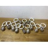 A collection of twelve silver plated teething rings with eight egg shaped and ribbon decorated