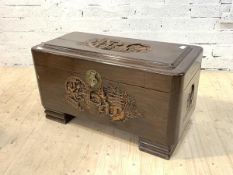 An eastern carved camphor wood blanket box, the hinged top revealing plain interior, raised on