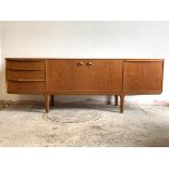 McIntosh, A mid century teak sideboard, the twin cupboard doors enclosing a shaped shelf, flanked by