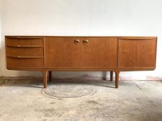 McIntosh, A mid century teak sideboard, the twin cupboard doors enclosing a shaped shelf, flanked by