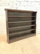 A large stained oak open waterfall bookcase, circa 1940, the raised back over moulded top and five