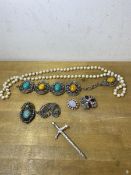 A collection of costume jewellery including a sword shaped bar brooch, panel bracelet, paste