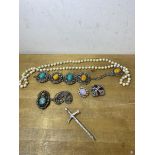 A collection of costume jewellery including a sword shaped bar brooch, panel bracelet, paste