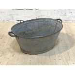 A twin handled galvanized bath tub or planter, H31cm, W80cm, D36cm