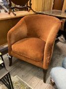 An early to mid 20th century upholstered tub chair, raised on square splayed front supports,