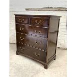 An Edwardian mahogany chest, the moulded top over two short and three long graduated drawers, raised