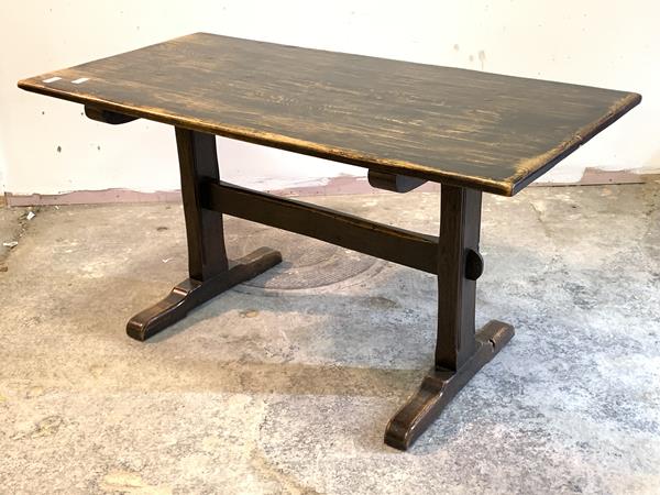 An oak refectory style dining table, the rectangular top raised on square supports with sledge feet,