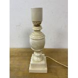 An alabaster table lamp of baluster form on stepped base measures 26cm high