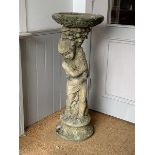A weathered reconstituted stone bird bath, the circular top on a figural base, H94cm