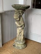 A weathered reconstituted stone bird bath, the circular top on a figural base, H94cm