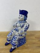 A Studio pottery figural jug in the form of a sitting man blue and white initials to base measures