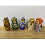 A group of five Russian nesting dolls, one depicting animals which measures 17cm high (6)