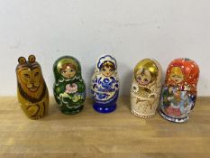 A group of five Russian nesting dolls, one depicting animals which measures 17cm high (6)