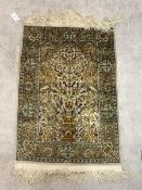 A Persian Hand knotted silk pile prayer rug, the central Mihrab with urn issuing foliate and