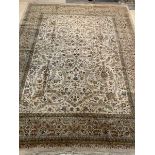 A large Sarouk carpet, the ivory ground with interlaced foliate framed within a triple guarded