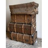 A group of three steamer trunks, together with an early 20th century leather holdall (Largest