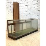 A large early 20th century glazed mahogany haberdashers shops display counter, the back fitted