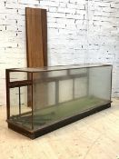 A large early 20th century glazed mahogany haberdashers shops display counter, the back fitted