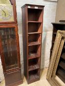 A stained pine floor standing bookcase, with five shelves, H163cm, W33cm, D32cm