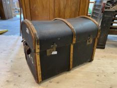 An early 20thc travelling trunk, dome topped with bent metal bound with brass bumpers, interior with