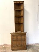 Ercol, A stained elm corner cabinet, with three open shelves over cupboard to base, H196cm, W68cm,