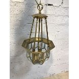 An Edwardian style brass ceiling pendent four branch light fitting, with sectional bevel glazed