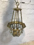 An Edwardian style brass ceiling pendent four branch light fitting, with sectional bevel glazed