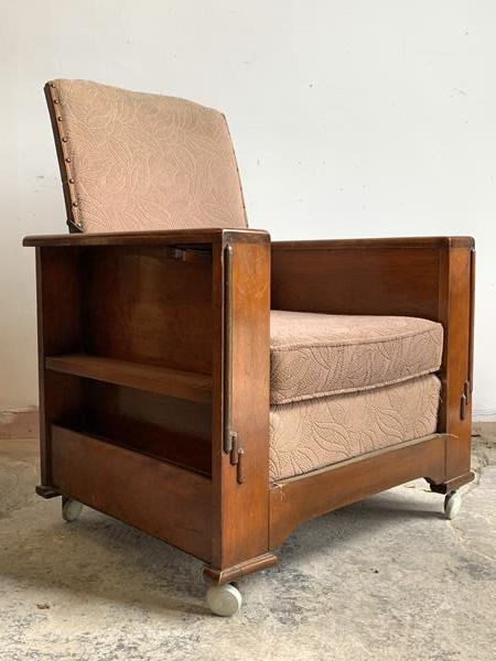 An Art Deco period walnut smokers reclining armchair, with upholstered seat and back, arms with