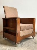 An Art Deco period walnut smokers reclining armchair, with upholstered seat and back, arms with