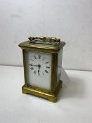 A late 19thc carriage clock with 4 glass roman numerals to dial, measures (with handle) 15cm high