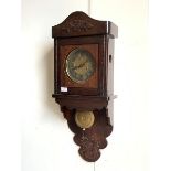 A Late 19th/ early 20th century wall clock, with a twin train spring driven eight day movement