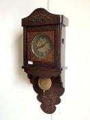 A Late 19th/ early 20th century wall clock, with a twin train spring driven eight day movement