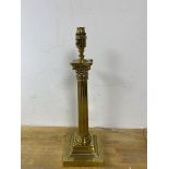 A corinthian column table lamp with brass finish measures 47cm high