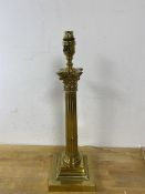 A corinthian column table lamp with brass finish measures 47cm high