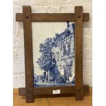 A tile wall art comprised of six tiles depicting city scene with figures in oak frame, measures 43cm