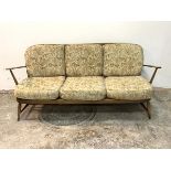 Ercol, A stained beech framed three seat sofa with upholstered squab cushions, H77cm, W170cm, D70cm