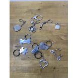 A collection of key chains, six marked silver, including a bone, puzzle piece, teddy bear, heart