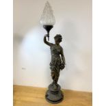 An Edwardian spelter Greek style lamp of lady holding a flaming torch with opaque glass shade on