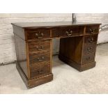 An Early 20th century mahogany twin pedestal desk, the top with inset writing surface over reeded