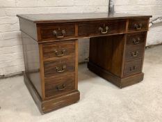 An Early 20th century mahogany twin pedestal desk, the top with inset writing surface over reeded