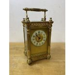 An Edwardian four glass carriage clock with Arabic numerals and gilt decoration measures 15cm high