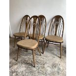 Ercol, A set of four elm and beech dining chairs, with hoop, spindle and swan carved splat back,